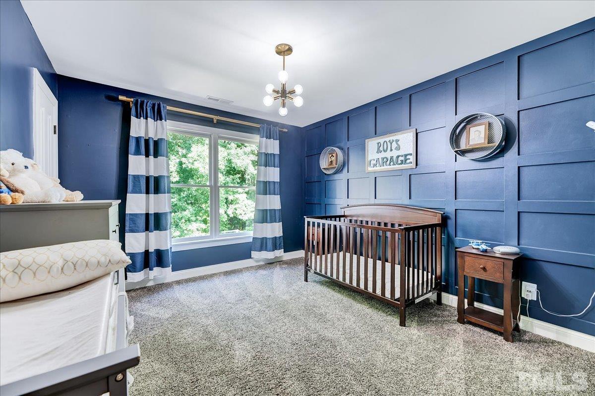 7033 Daniel Road Wake Forest, NC 27587 - Photo 33 of 63 a bedroom with a bed and a large window