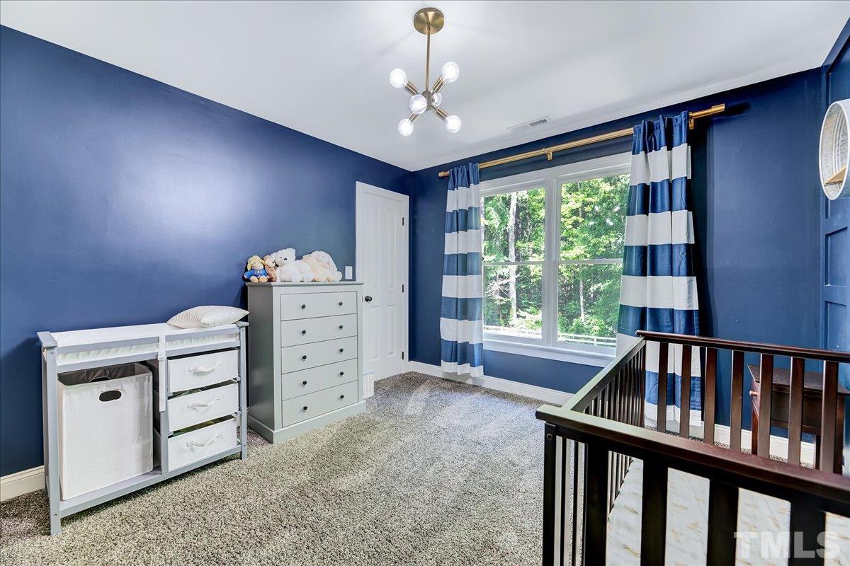 7033 Daniel Road Wake Forest, NC 27587 - Photo 34 of 63 a view of a bedroom with furniture and windows