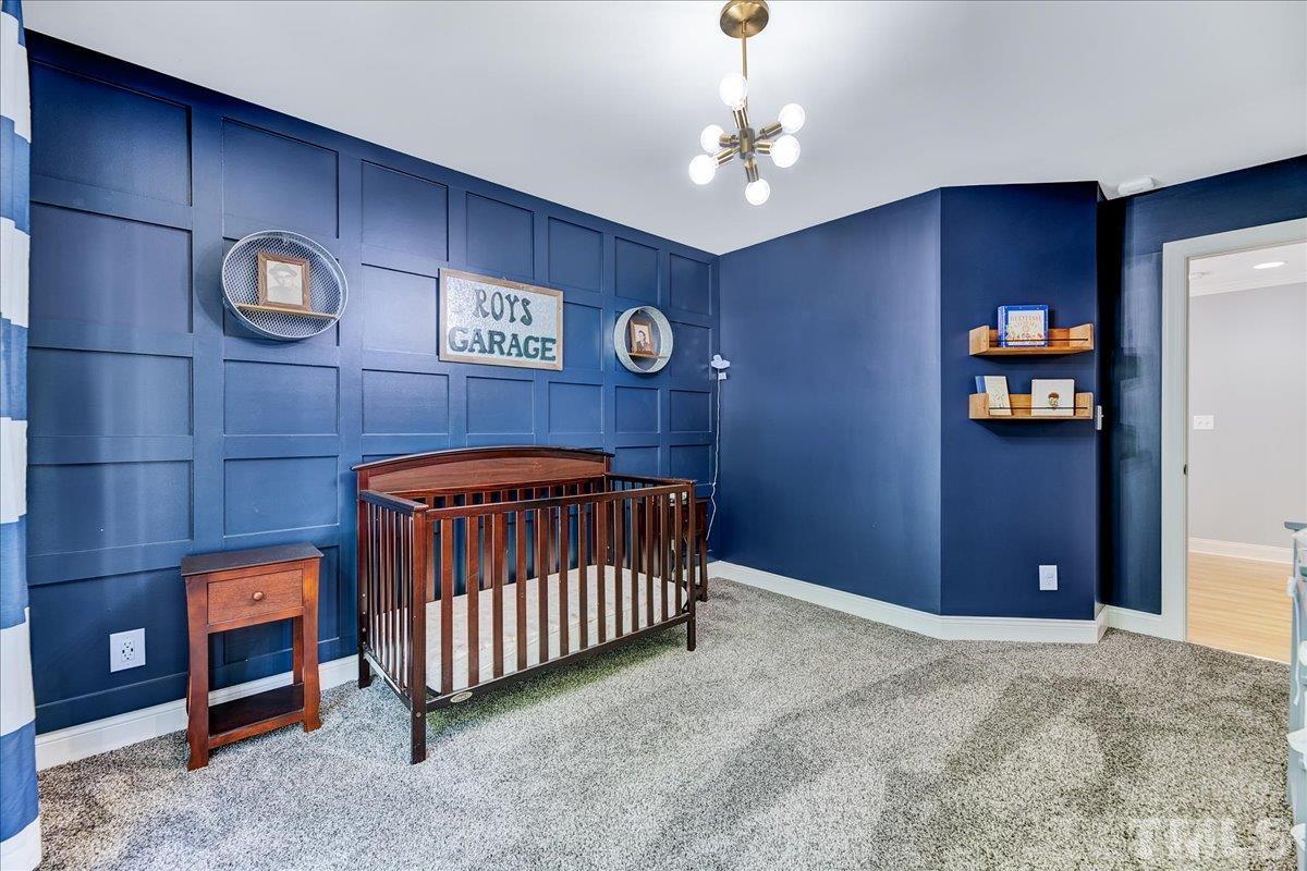 7033 Daniel Road Wake Forest, NC 27587 - Photo 35 of 63 a bedroom with a bed and a table