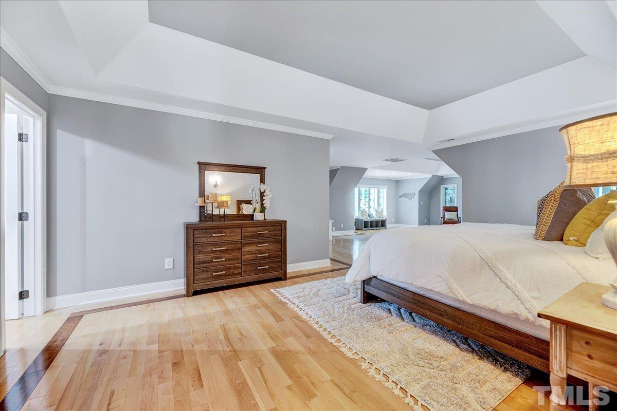 7033 Daniel Road Wake Forest, NC 27587 - Photo 37 of 63 a bed room with a bed and a dresser