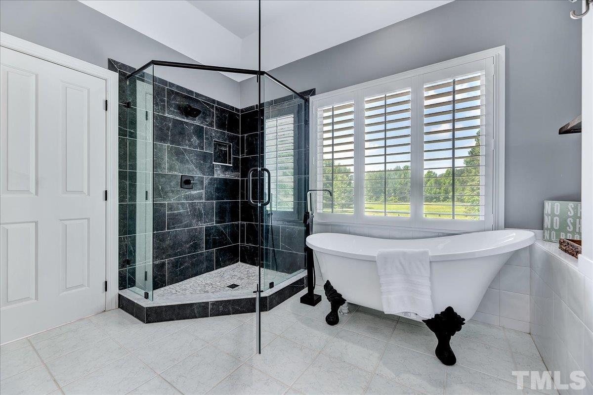 7033 Daniel Road Wake Forest, NC 27587 - Photo 45 of 63 a spacious bedroom with a bed and a window