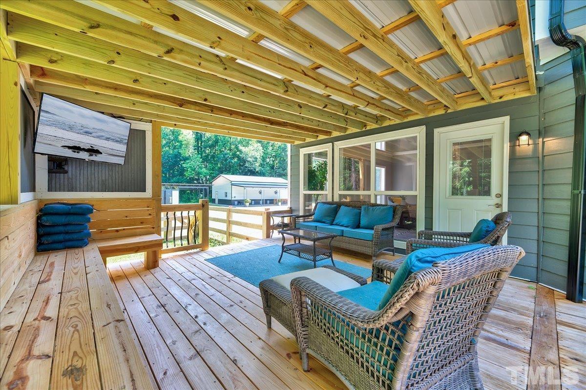 7033 Daniel Road Wake Forest, NC 27587 - Photo 48 of 63 a living room with patio furniture and a wooden floor