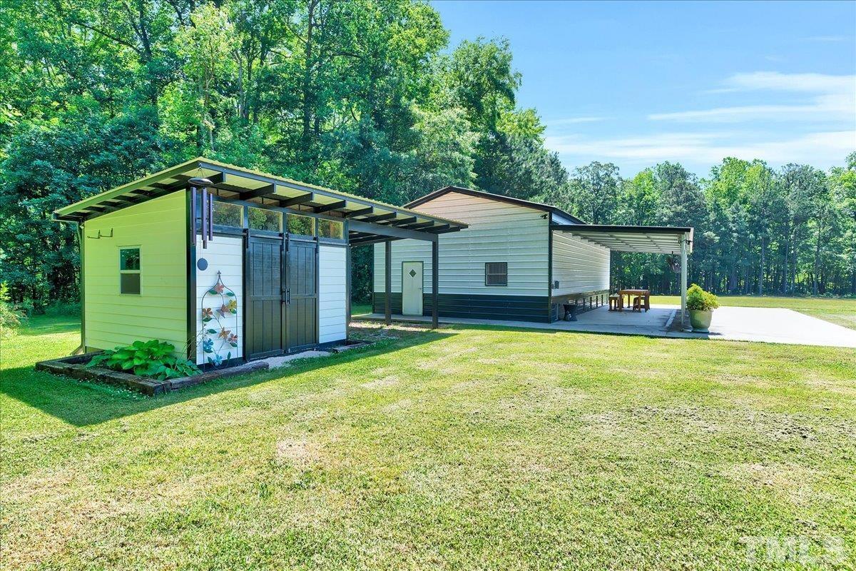 7033 Daniel Road Wake Forest, NC 27587 - Photo 51 of 63 a front view of a house with a garden