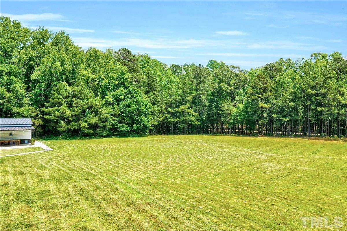 7033 Daniel Road Wake Forest, NC 27587 - Photo 53 of 63 a view of a large yard with an outdoor space and seating area
