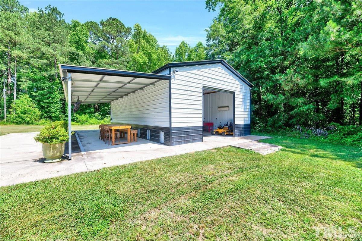 7033 Daniel Road Wake Forest, NC 27587 - Photo 54 of 63 a house view with a garden space