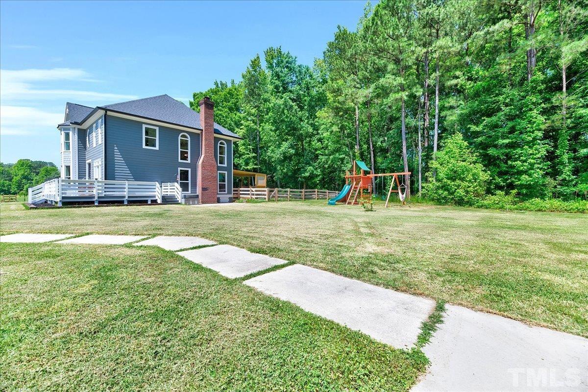 7033 Daniel Road Wake Forest, NC 27587 - Photo 57 of 63 a view of a house with a yard and sitting area