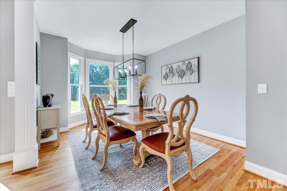 7033 Daniel Road Wake Forest, NC 27587 - Photo 8 of 63 a view of a dining room with furniture window and wooden floor