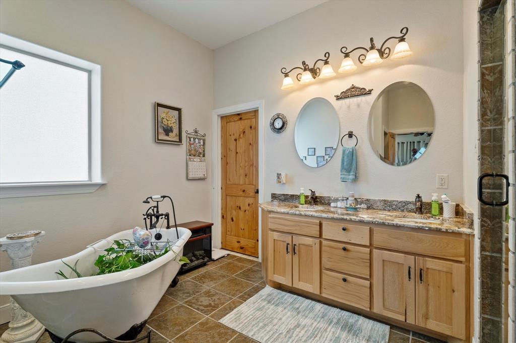 2801 Agnes Circle Springtown, TX 76082 - Photo 21 of 40 a bathroom with a granite countertop sink and a mirror