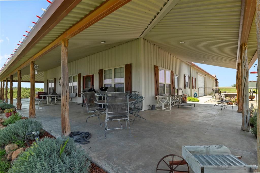 2801 Agnes Circle Springtown, TX 76082 - Photo 32 of 40 a view of a patio with table and chairs and potted plants