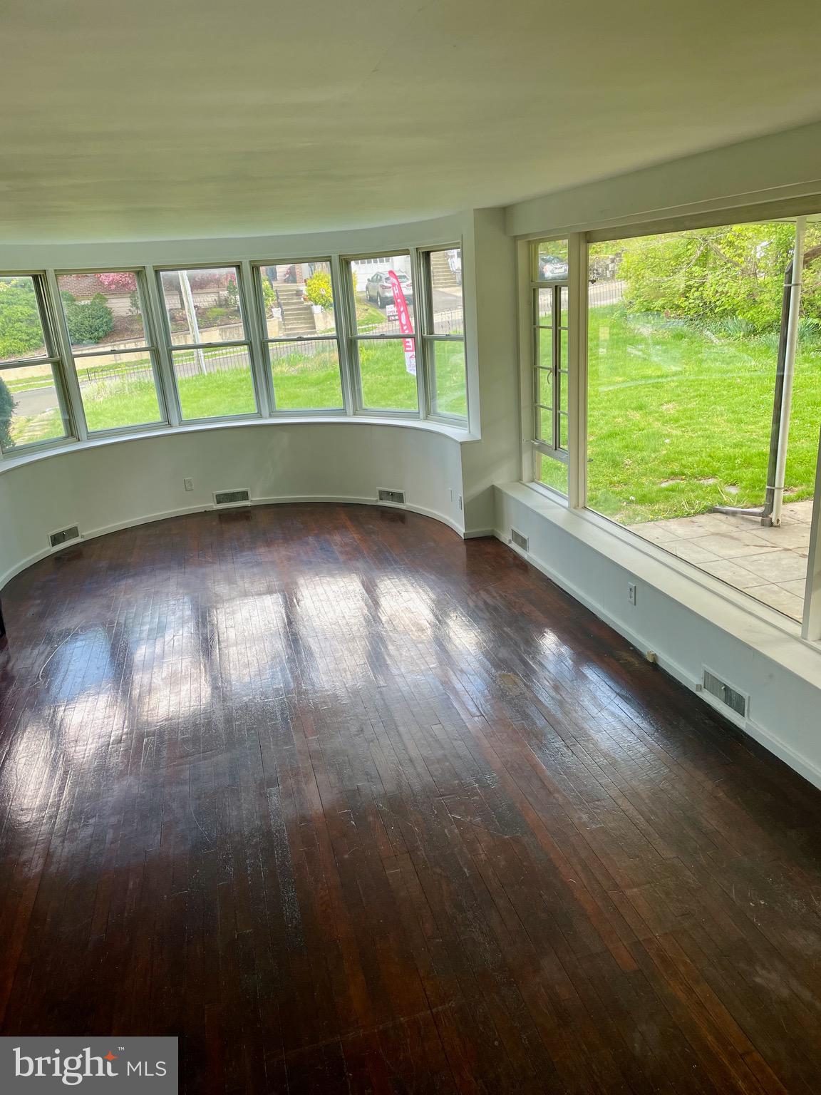 119 Robbins Avenue Jenkintown, PA 19046 - Photo 12 of 65 a view of an empty room with wooden floor and windows