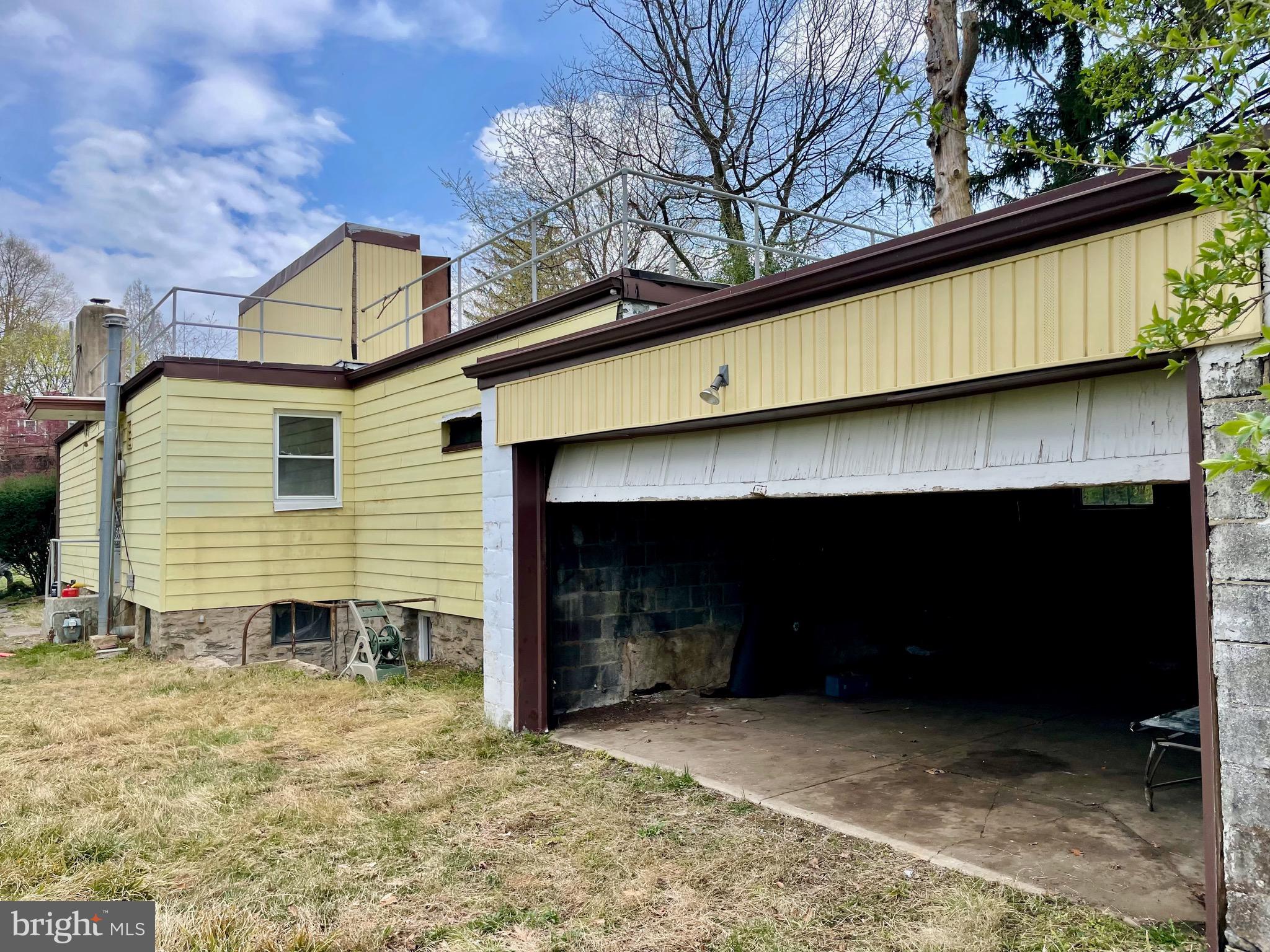 119 Robbins Avenue Jenkintown, PA 19046 - Photo 32 of 65 a backyard of a house with wooden fence and a garage