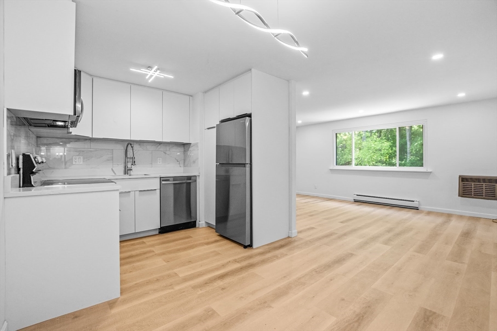75 Nicholas Road, Unit K Framingham, MA 01701 - Photo 2 of 24 a kitchen with a refrigerator and window