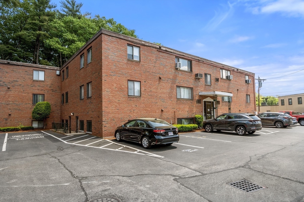 75 Nicholas Road, Unit K Framingham, MA 01701 - Photo 23 of 24 a car parked in front of a building