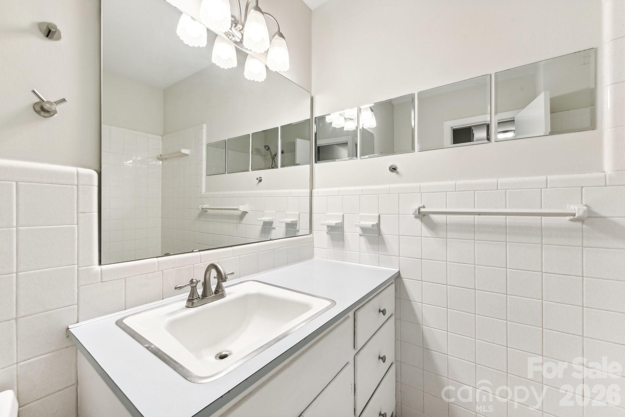 1334 Briar Creek Road, Unit 2 Charlotte, NC 28205 - Photo 15 of 30 a bathroom with a sink and a mirror