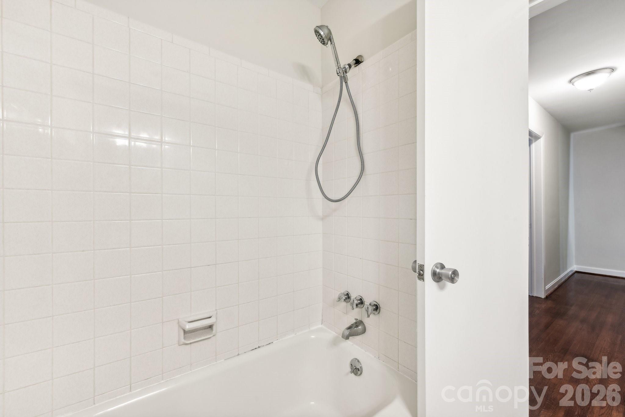 1334 Briar Creek Road, Unit 2 Charlotte, NC 28205 - Photo 16 of 30 a bathroom with a bath tub with a shower