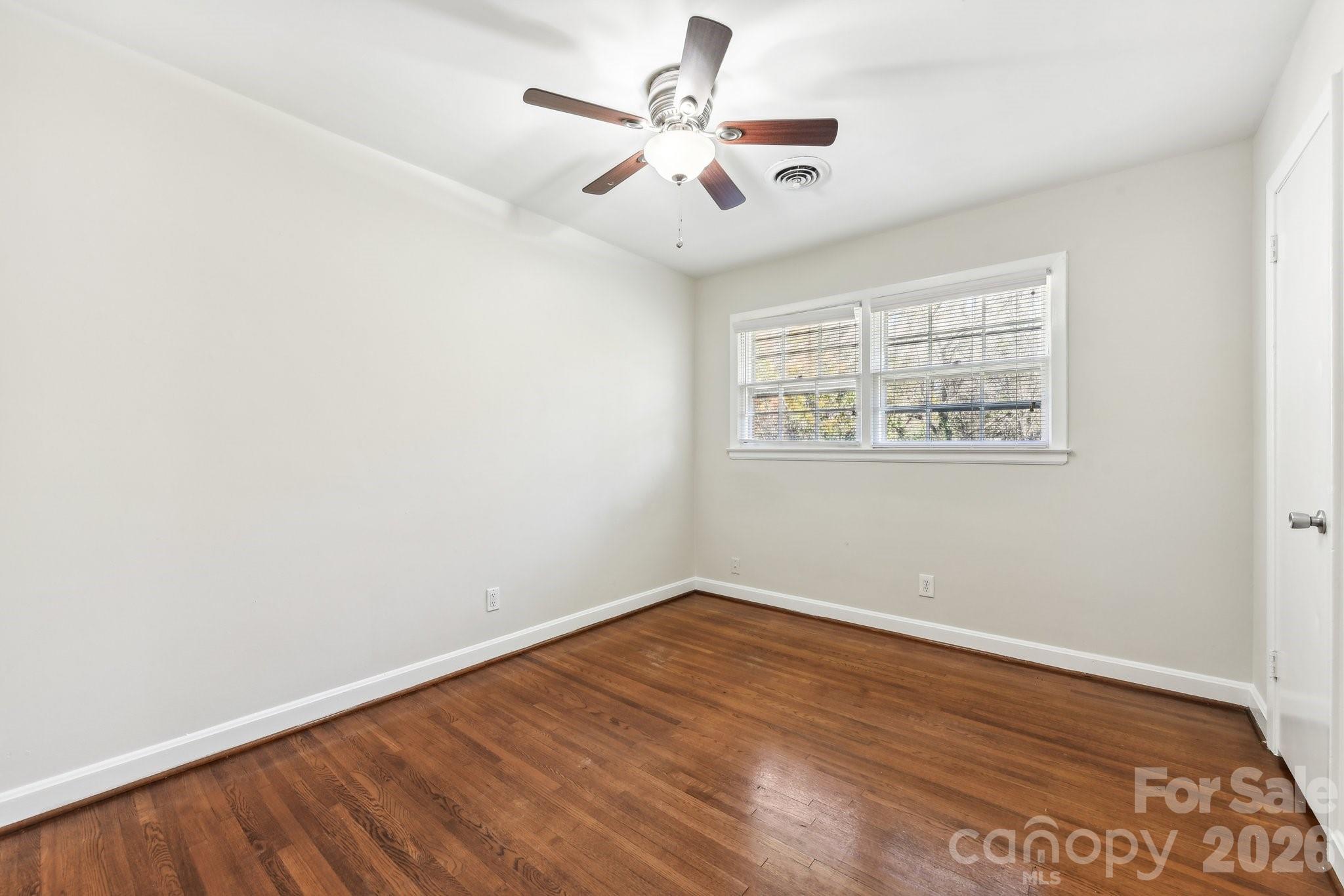 1334 Briar Creek Road, Unit 2 Charlotte, NC 28205 - Photo 17 of 30 an empty room with wooden floor and windows