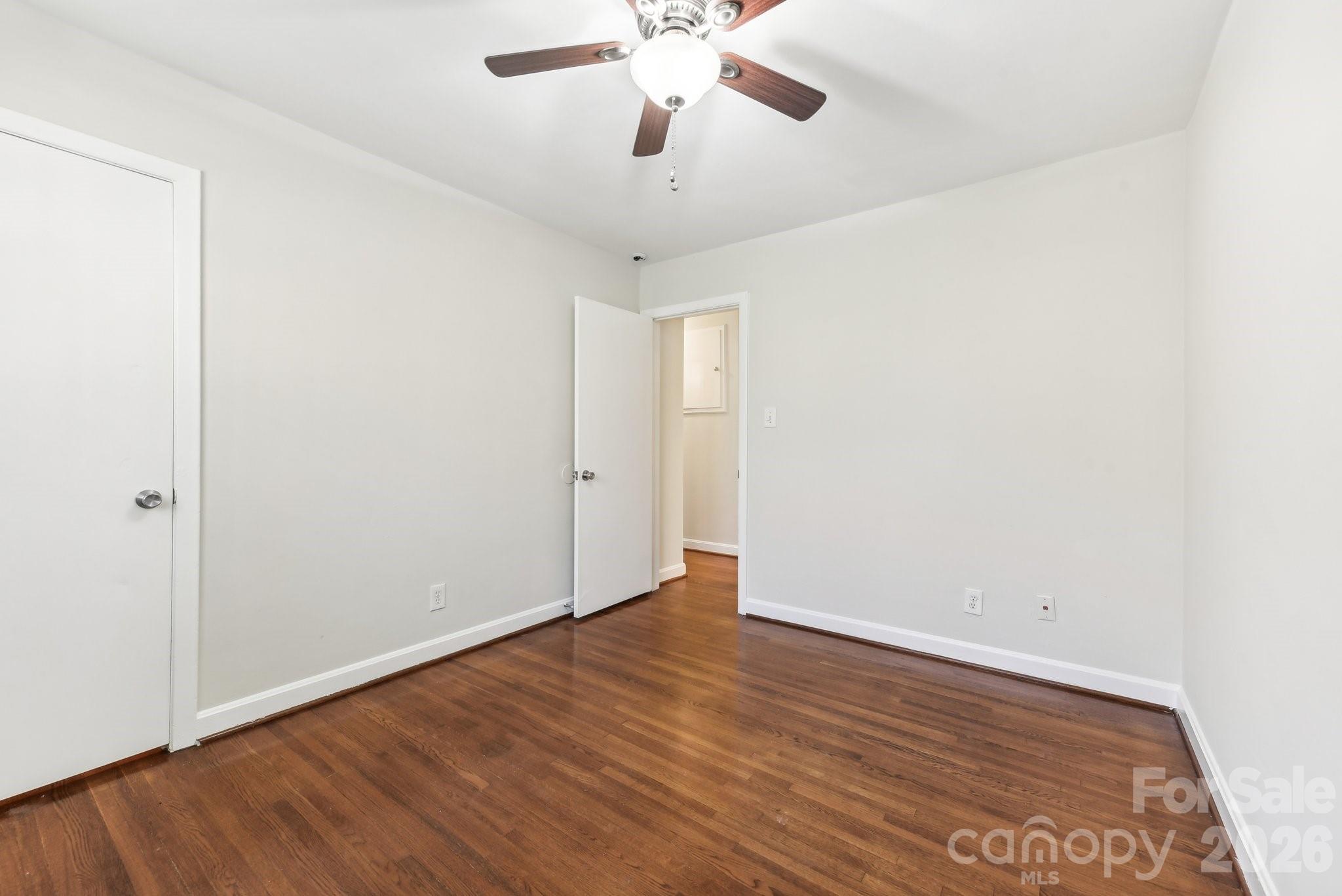 1334 Briar Creek Road, Unit 2 Charlotte, NC 28205 - Photo 18 of 30 an empty room with wooden floor and windows