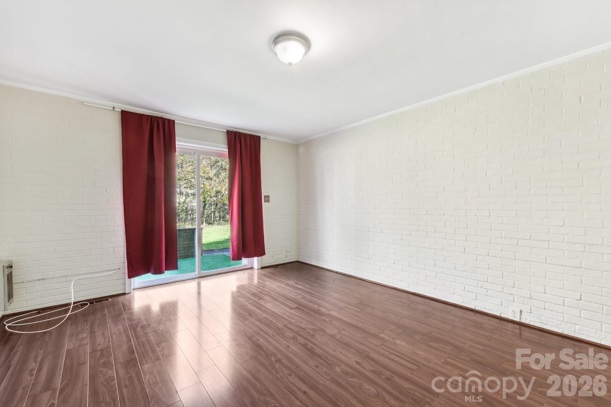 1334 Briar Creek Road, Unit 2 Charlotte, NC 28205 - Photo 20 of 30 an empty room with wooden floor and windows