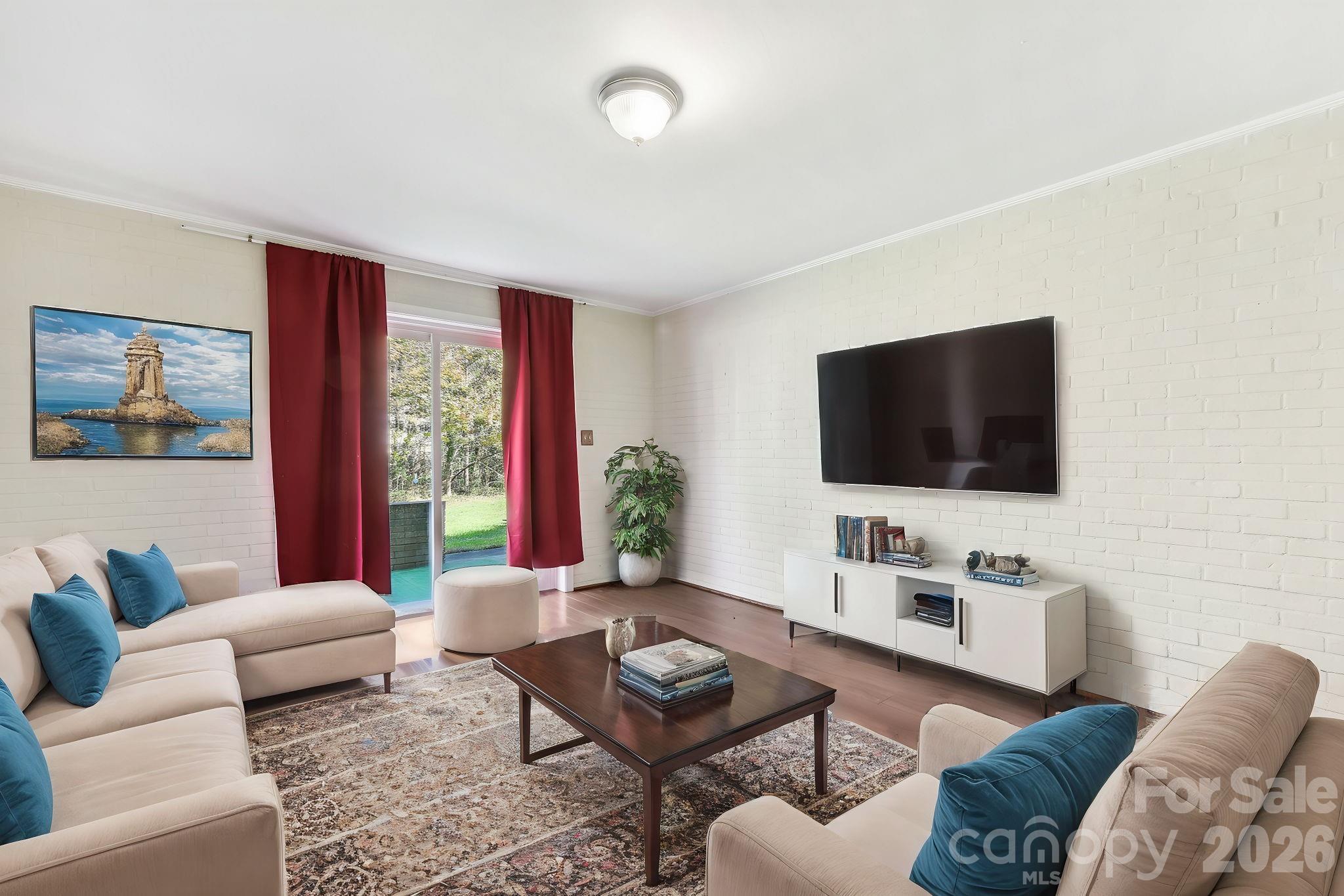 1334 Briar Creek Road, Unit 2 Charlotte, NC 28205 - Photo 21 of 30 a living room with furniture and a flat screen tv