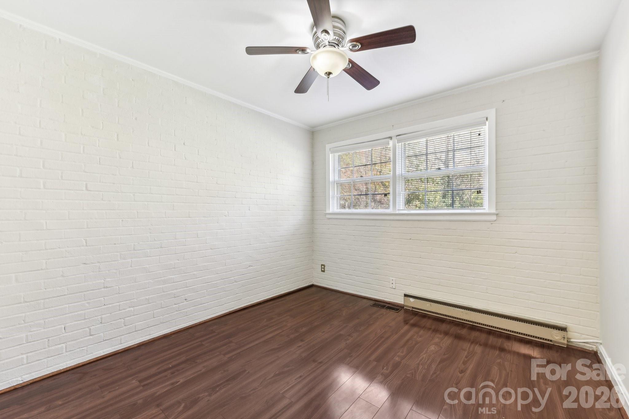 1334 Briar Creek Road, Unit 2 Charlotte, NC 28205 - Photo 22 of 30 wooden floor in an empty room with a window
