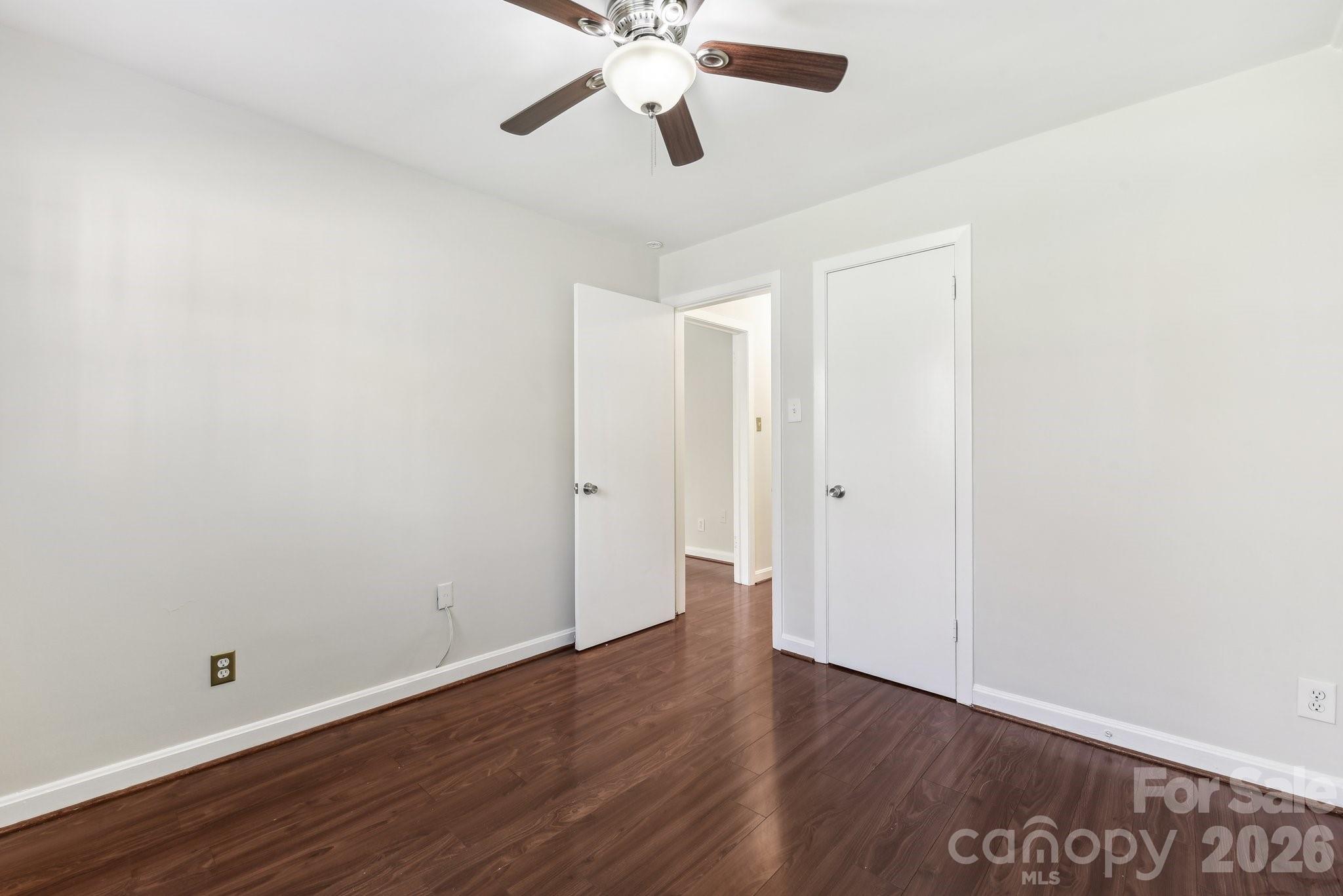 1334 Briar Creek Road, Unit 2 Charlotte, NC 28205 - Photo 24 of 30 a view of an empty room with wooden floor
