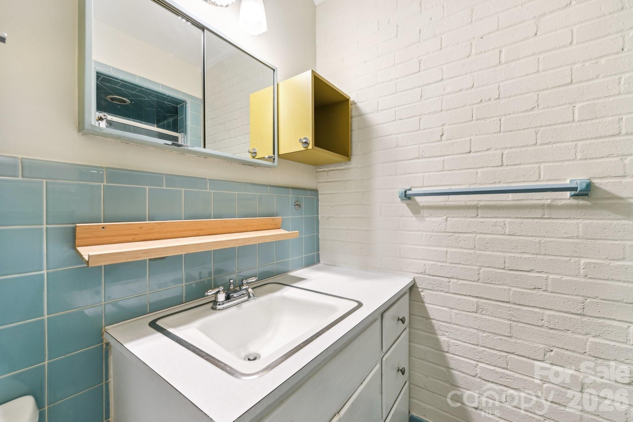 1334 Briar Creek Road, Unit 2 Charlotte, NC 28205 - Photo 25 of 30 a bathroom with a sink and a mirror