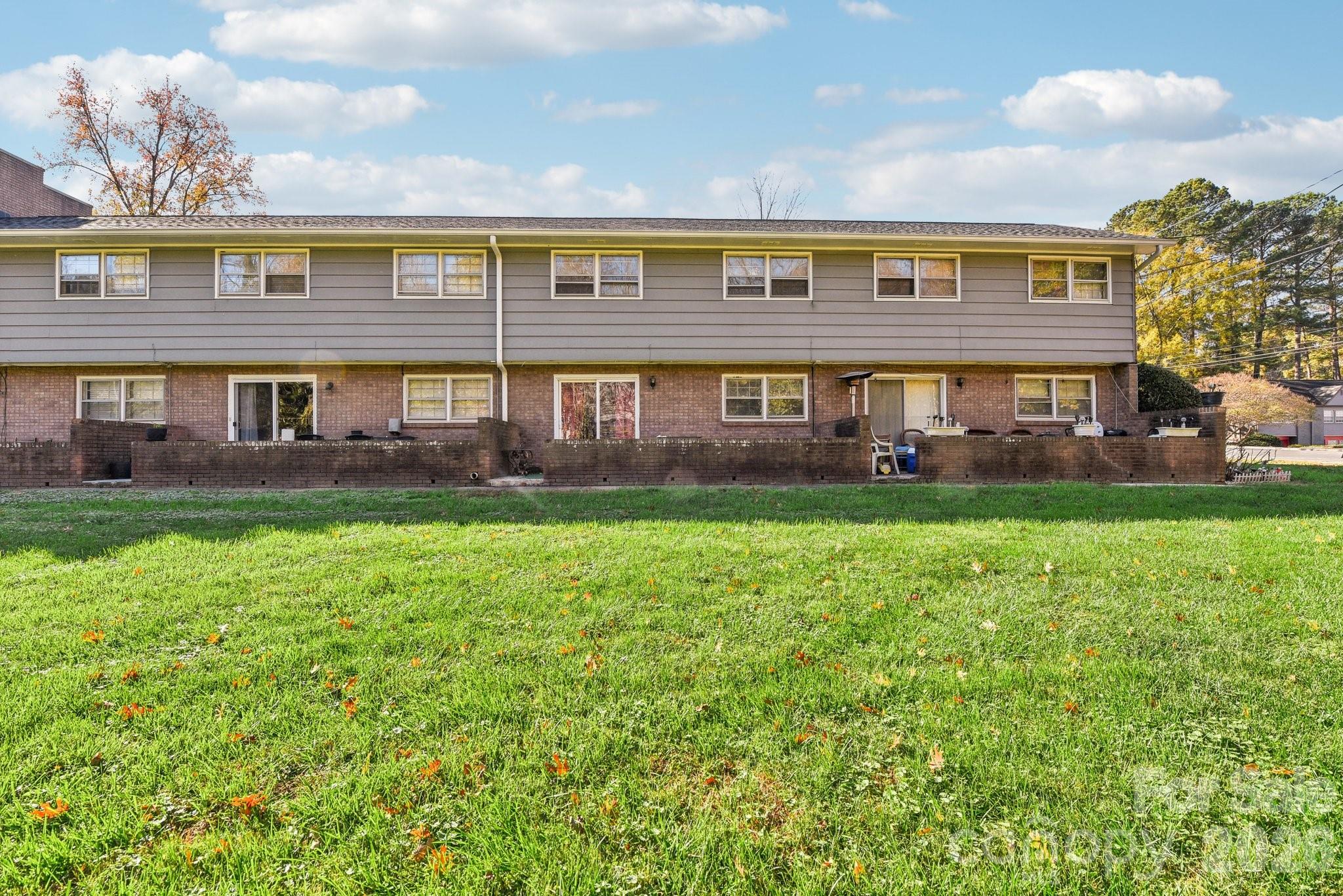 1334 Briar Creek Road, Unit 2 Charlotte, NC 28205 - Photo 28 of 30 a large building with a yard in front of it