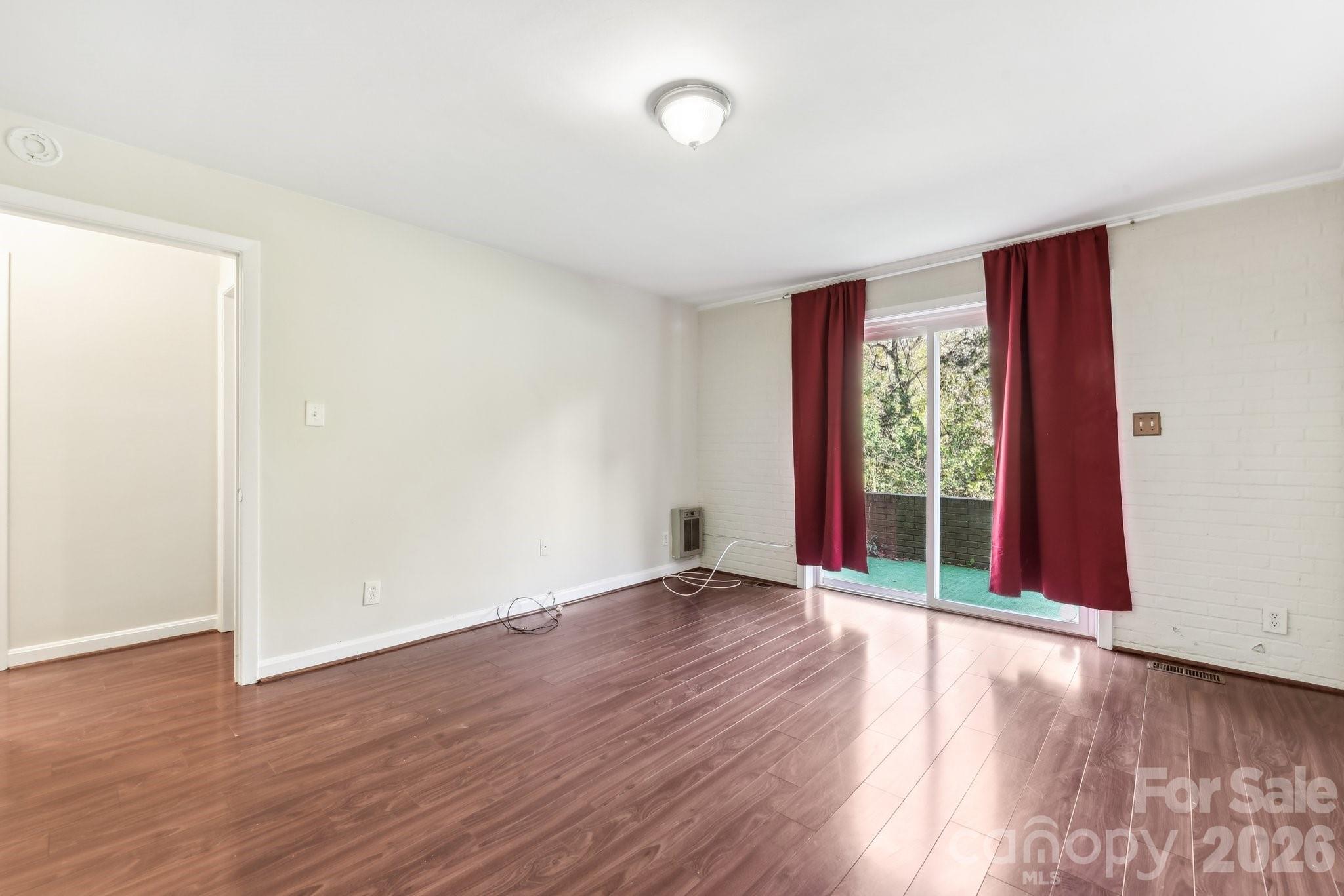 1334 Briar Creek Road, Unit 2 Charlotte, NC 28205 - Photo 3 of 30 an empty room with wooden floor and windows