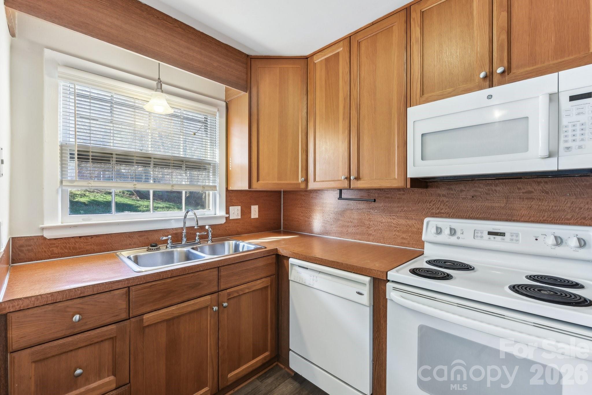 1334 Briar Creek Road, Unit 2 Charlotte, NC 28205 - Photo 9 of 30 a kitchen with a sink a stove cabinets and a window