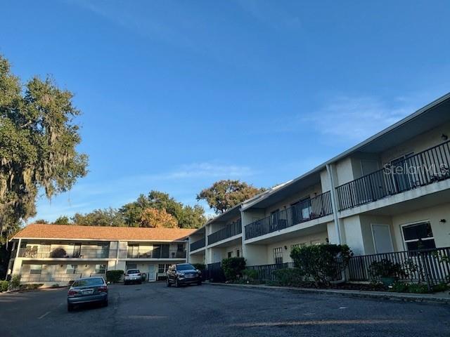 680 West Osceola Street, Unit 101 Clermont, FL 34711 - Photo 17 of 18 a city street with tall buildings and a street view