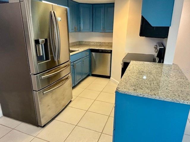 680 West Osceola Street, Unit 101 Clermont, FL 34711 - Photo 9 of 18 a kitchen with stainless steel appliances granite countertop a refrigerator and a sink