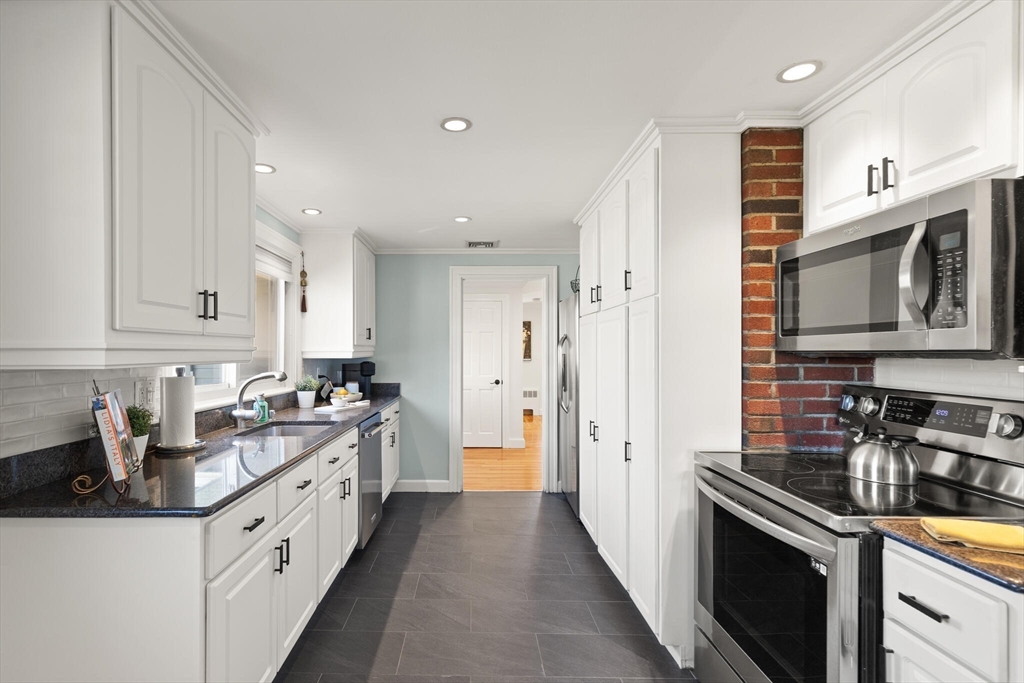 40 Friend Street Wakefield, MA 01880 - Photo 11 of 34 a kitchen with stainless steel appliances granite countertop a sink stove refrigerator and cabinets