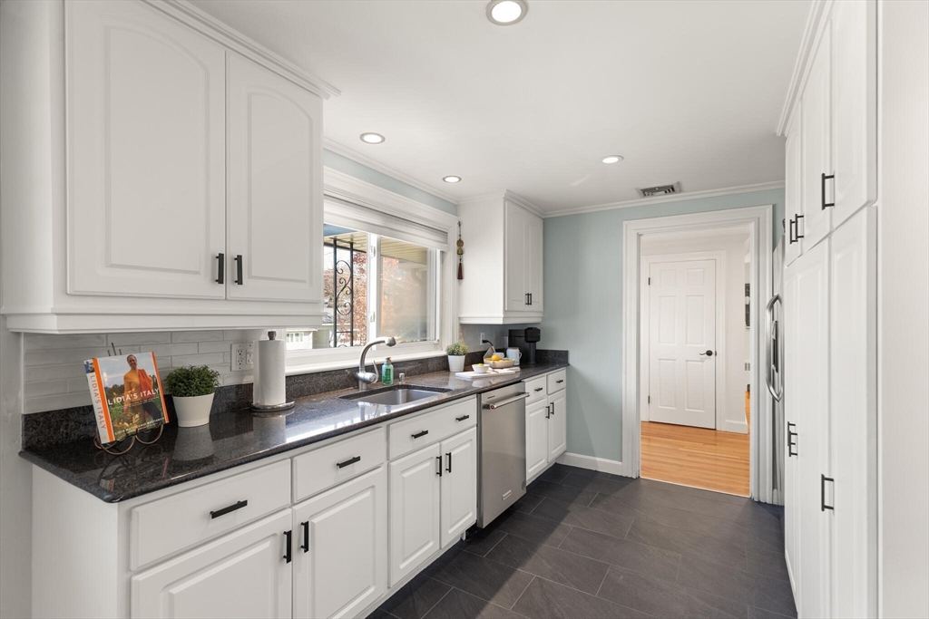 40 Friend Street Wakefield, MA 01880 - Photo 12 of 34 a kitchen with stainless steel appliances granite countertop a sink and cabinets
