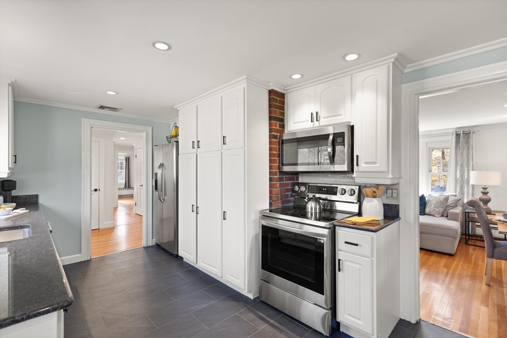 40 Friend Street Wakefield, MA 01880 - Photo 13 of 34 a kitchen with stainless steel appliances a stove a refrigerator and a sink
