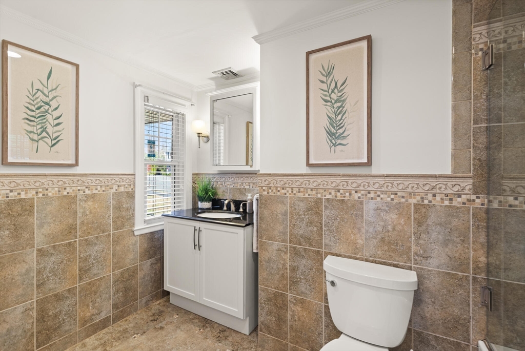 40 Friend Street Wakefield, MA 01880 - Photo 16 of 34 a bathroom with a toilet a sink and mirror