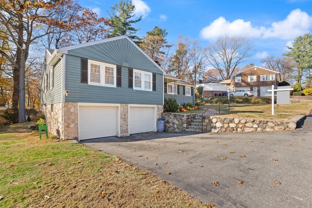40 Friend Street Wakefield, MA 01880 - Photo 2 of 34 a front view of a house with a yard and garage