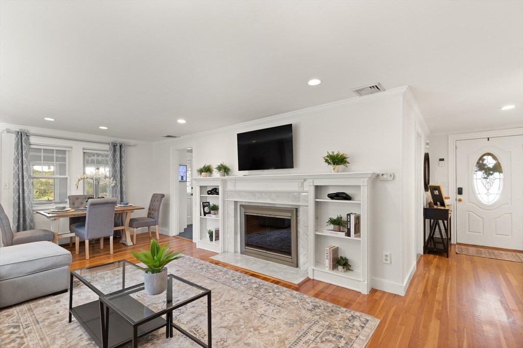 40 Friend Street Wakefield, MA 01880 - Photo 6 of 34 a living room with furniture a fireplace and a flat screen tv