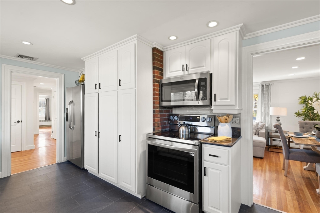40 Friend Street Wakefield, MA 01880 - Photo 10 of 34 a kitchen with stainless steel appliances a stove a sink and a refrigerator