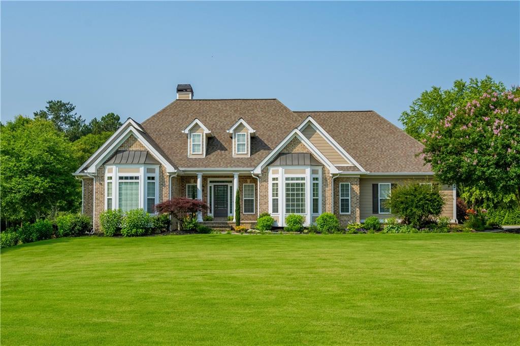 a front view of house with yard and green space