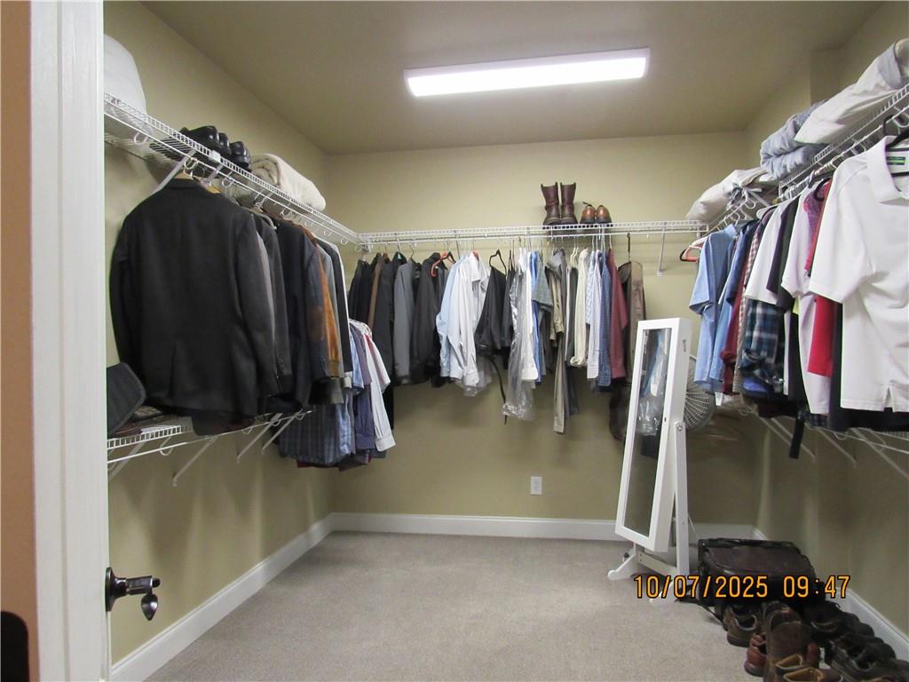 815 Spring View Court Covington, GA 30014 - Photo 14 of 43 a view of walk in closet with clothes and shoes