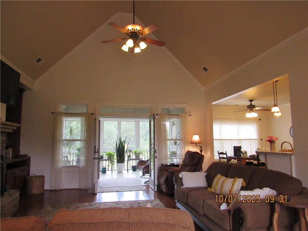 815 Spring View Court Covington, GA 30014 - Photo 15 of 43 a living room with furniture a chandelier and a flat screen tv