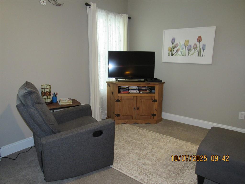 815 Spring View Court Covington, GA 30014 - Photo 23 of 43 a living room with furniture and a flat screen tv