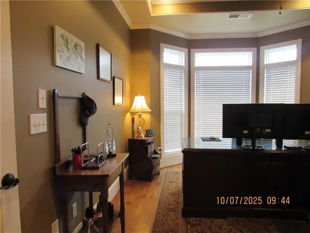 a living room with furniture a desk and chair with windows