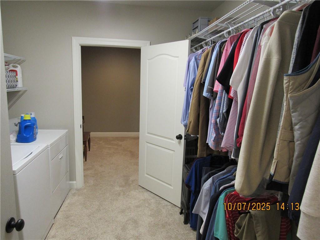 815 Spring View Court Covington, GA 30014 - Photo 28 of 43 a view of walk in closet with clothes and shoes