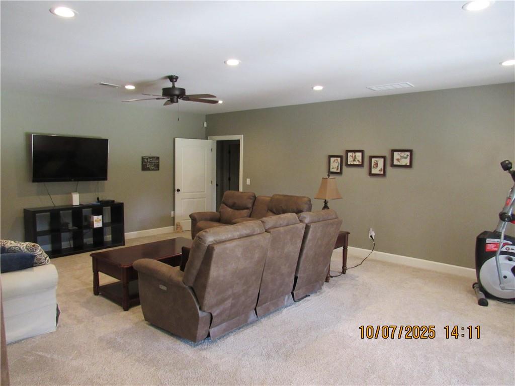 815 Spring View Court Covington, GA 30014 - Photo 33 of 43 a living room with furniture and a flat screen tv