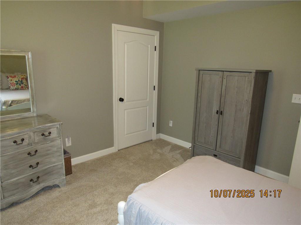 815 Spring View Court Covington, GA 30014 - Photo 37 of 43 a bedroom with a bed and a dresser in it