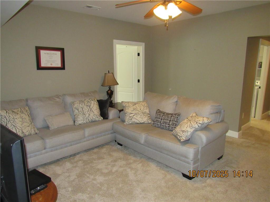 815 Spring View Court Covington, GA 30014 - Photo 41 of 43 a living room with furniture and a chandelier