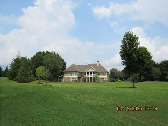 a view of house with outdoor space and garden