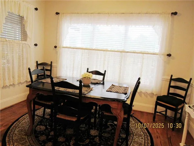 a view of a workspace with furniture and window