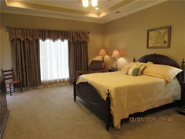 a spacious bedroom with a bed and a window